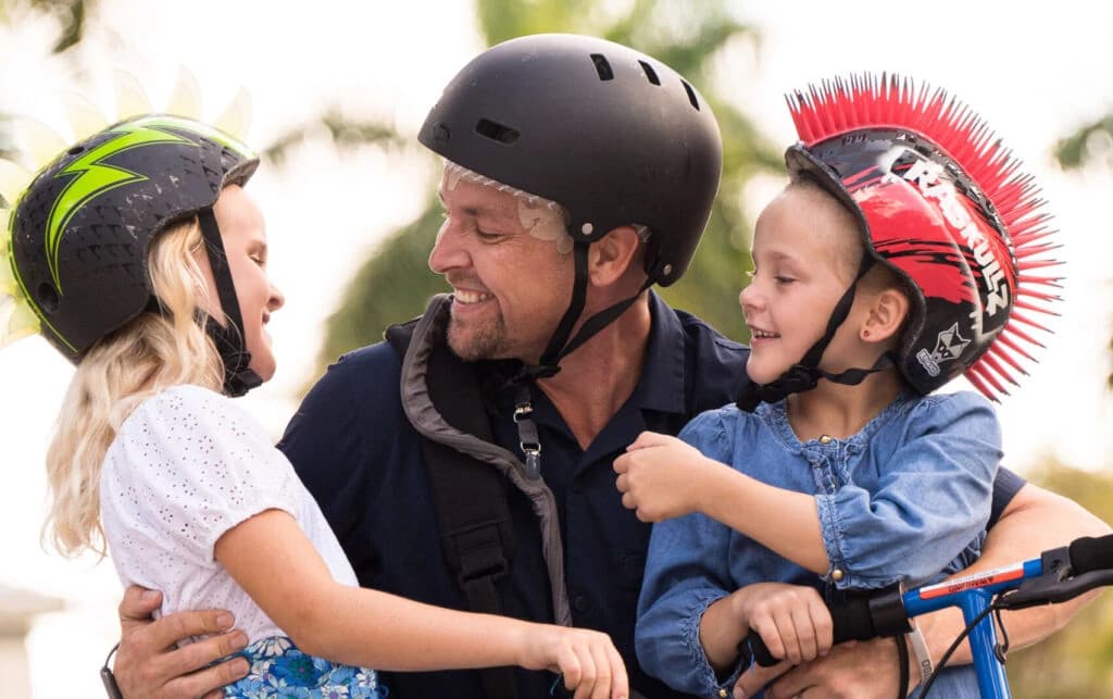 Portrait of a confident man named Mike smiling against a bright blue background