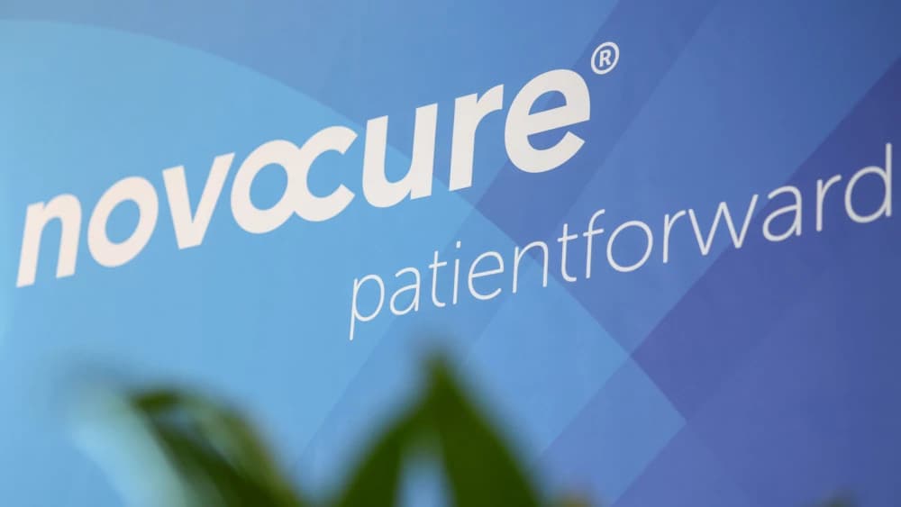 Smiling elderly woman with short white hair looking hopeful and confident