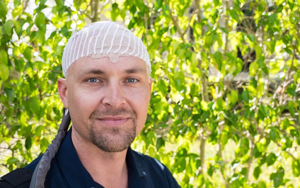 Portrait of Mike, a professional man smiling confidently against a neutral background