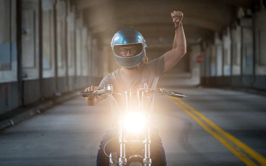 Disc jockey performing at a vibrant event with colorful stage lights
