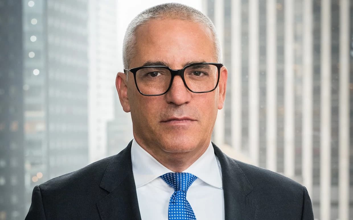 Portrait of a confident professional man wearing glasses and a suit in a modern office setting