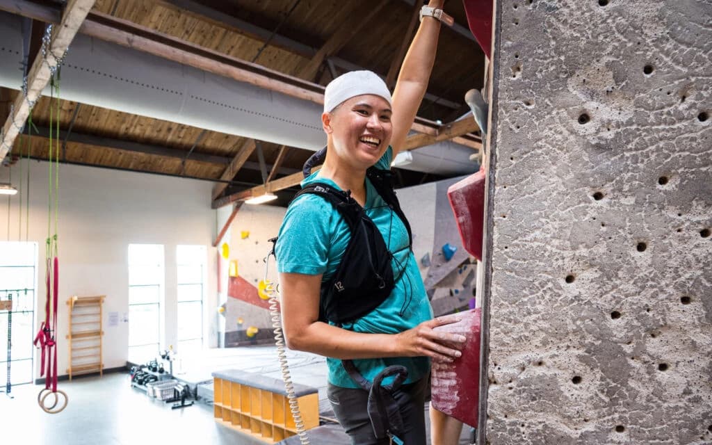 Smiling man standing with arms crossed in a modern office space