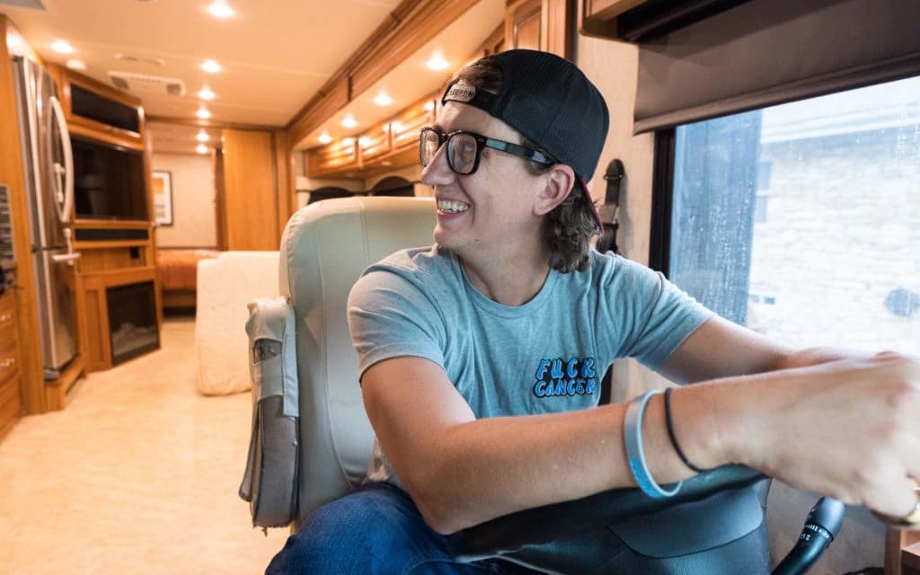 Novocure scientist analyzing cancer treatment data on multiple digital screens in a high-tech laboratory